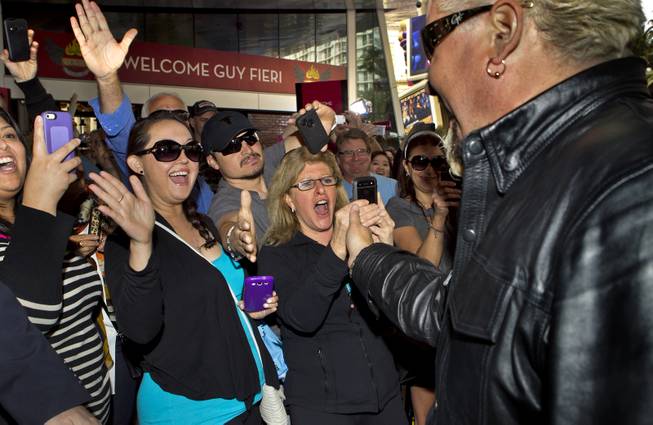Guy Fieri greets his fans at The Quad as he arrives to introduce his first Las Vegas restaurant Guy Fieri's Vegas Kitchen & Bar on Friday, April 4, 2014.