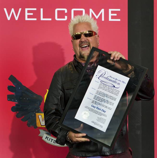 Guy Fieri shows off his mayor's proclamation to fans outside his first Las Vegas restaurant Guy Fieri's Vegas Kitchen & Bar on Friday, April 4, 2014.
