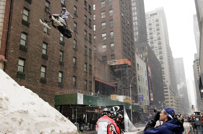 Snowmobile rider Jay Quinlan, 25, rehearses a jump he is performing later Monday for the "Late Show with David Letterman" television show onto a mound of snow on a New York street on Feb 28, 2005. Quinlan will be riding in Outdoor Life Network's Winter Gravity Games which will be airing on OLN starting March 27, 2005.