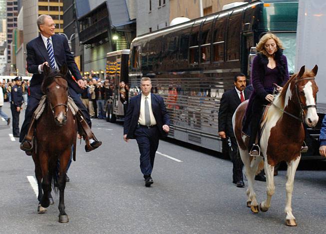 In this photo released by CBS, Madonna and David Letterman ride horses on New York's West 53rd Street when the music superstar appeared on The Late Show with David Letterman, Thursday, Oct. 20, 2005. This is Madonnas first visit to the Late Show since Nov. 11, 2003. 