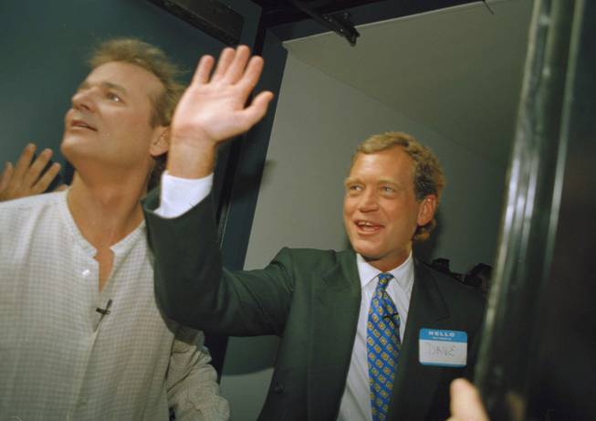 David Letterman, right, and Bill Murray wave from the side door of the Ed Sullivan Theater in New York on Monday, August 30, 1993. 