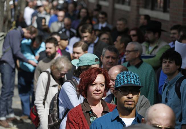In this Thursday March 13, 2014, file photo, job seekers line up to attend a marijuana industry job far in Downtown Denver.