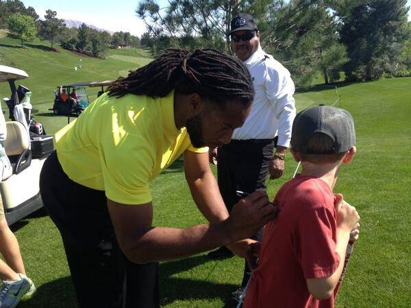 Larry Fitzgerald signs an autograph on opening day of the 2014 Michael Jordan Celebrity Invitational pro-am golf tournament Thursday, April 3, 2014, at Shadow Creek Golf Course.