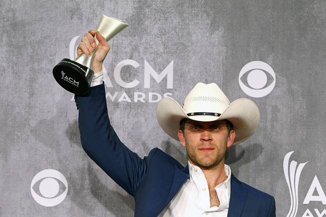 Justin Moore holds his trophy for New Artist of the Year in the photo room during the 49th Academy of Country Music Awards on Sunday, April 6, 2014, at MGM Grand Garden Arena.