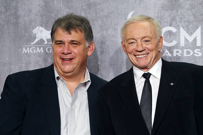 Academy of Country Music's President Bob Romero, left, poses with Dallas Cowboys owner Jerry Jones in the photo room during the 49th Academy of Country Music Awards at the MGM Grand Garden Arena Sunday, April 6, 2014. The 2015 ACMA show will be held at the AT&T Stadium in Texas.