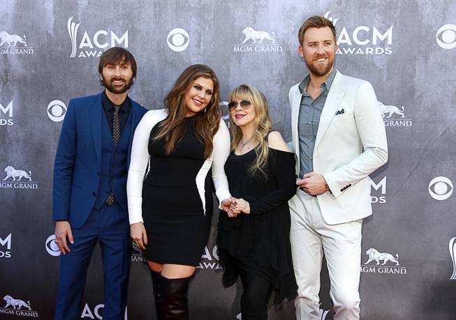 Singer Stevie Nicks, second from right, poses with members of Lady Antebellum, from left, Dave Haywood, Hillary Scott and Charles Kelley, as they arrive for the 49th Academy of Country Music Awards show at the MGM Grand Garden Arena Sunday, April 6, 2014.