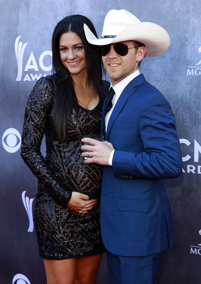 Justin Moore and his wife Kate arrive for the 49th Academy of Country Music Awards on Sunday, April 6, 2014, at MGM Grand Garden Arena.