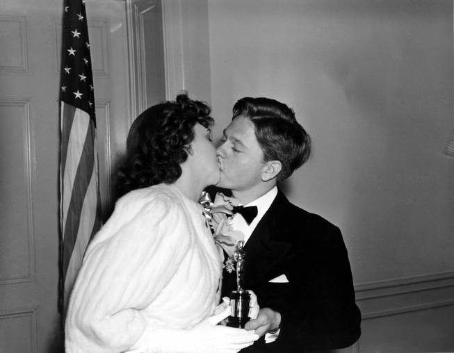 Judy Garland receives a kiss from Mickey Rooney as she is given a special award Oscar for her outstanding performance as a screen juvenile during the past years at the 1939 Academy Awards presented at the Ambassador Hotel, Los Angeles, Ca., Feb. 29, 1940. 