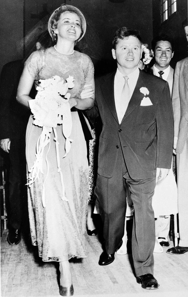 Actor Mickey Rooney and his bride, actress Martha Vickers, smile happily as they walk down the aisle of a church in North Hollywood, Calif., shortly after their wedding ceremony, June 3, 1949. 