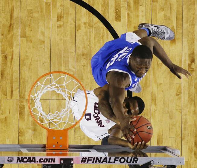 Kentucky forward Julius Randle (30) tries to block the ball from Connecticut forward Phillip Nolan (0) during the first half of the NCAA Final Four tournament college basketball championship game Monday, April 7, 2014, in Arlington, Texas. (AP Photo/David J. Phillip)