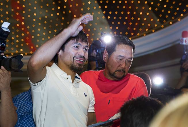 Boxer Manny Pacquiao of the Philippines makes his official arrival at the MGM Grand Tuesday, April 8, 2014. Pacquiao will challenge undefeated WBO welterweight champion Timothy Bradley at the MGM Grand Garden Arena on Saturday. The fight is a rematch to a June 9, 2012 fight that Bradley won.