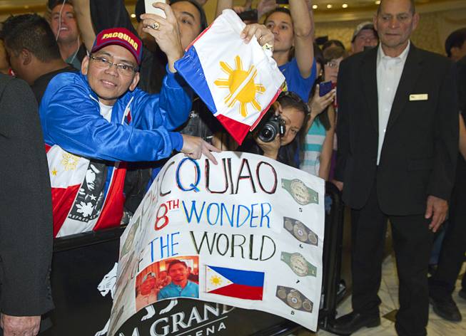 A fan waits for boxer Manny Pacquiao of the Philippines at the MGM Grand Tuesday, April 8, 2014. Pacquiao will challenge undefeated WBO welterweight champion Timothy Bradley at the MGM Grand Garden Arena on Saturday. The fight is a rematch to a June 9, 2012 fight that Bradley won.
