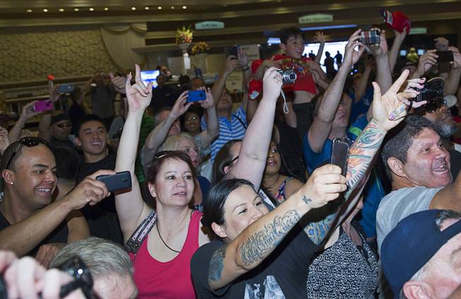 Fans try to get photos of boxer Manny Pacquiao of the Philippines at the MGM Grand Tuesday, April 8, 2014. Pacquiao will challenge undefeated WBO welterweight champion Timothy Bradley at the MGM Grand Garden Arena on Saturday. The fight is a rematch to a June 9, 2012 fight that Bradley won.