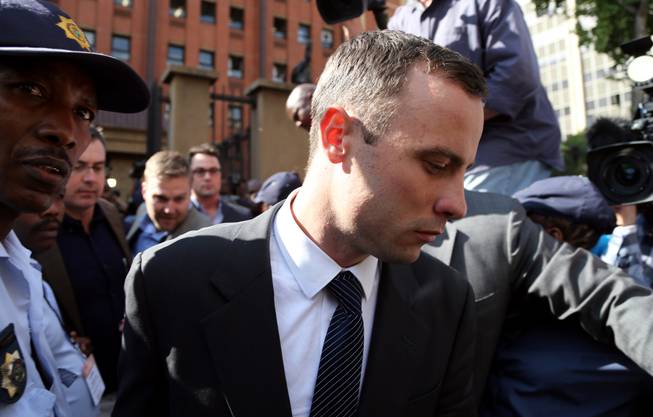 Oscar Pistorius, leaves the high court in Pretoria, South Africa, Tuesday, April 8, 2014. Pistorius is charged with murder for the shooting death of his girlfriend, Reeva Steenkamp, on Valentines Day in 2013.