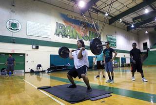 Brian Arcadia lifts weights at Rancho High School Monday, April 7, 2014. Susan Spencer's nonprofit A Level Playing Field has given more than $30,000 of equipment and funds to the Rancho HS football team.