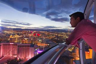 Alejandro Higuera of Mexico rides the 550 foot-tall High Roller observation wheel, the tallest in the world, Wednesday, April 9, 2014. The wheel is the centerpiece of the $550 million Linq project, a retail, dining and entertainment district by Caesars Entertainment Corp.