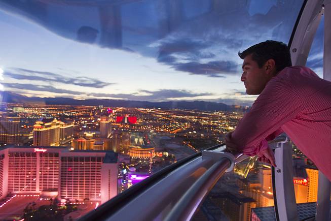 Alejandro Higuera of Mexico rides the 550 foot-tall High Roller observation wheel, the tallest in the world, Wednesday, April 9, 2014.