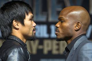 Boxer Manny Pacquiao, left, of the Philippines and undefeated WBO welterweight champion Timothy Bradley face off during a news conference at the MGM Grand Wednesday, April 9, 2014. Pacquiao will challenge Bradley at the MGM Grand Garden Arena on Saturday. The fight is a rematch to a June 9, 2012 fight that Bradley won.
