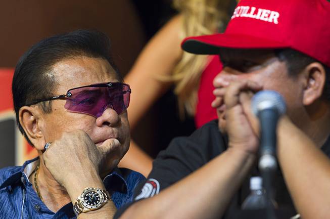 Chavit Singson (L), governor of Ilocos Sur province in the Philippines, listens to Pacquiao's Filipino trainer Buboy Fernandez during a boxing news conference at the MGM Grand Wednesday, April 9, 2014. Manny Pacquiao of the Philippines will challenge undefeated WBO welterweight champion Timothy Bradley at the MGM Grand Garden Arena on Saturday. The fight is a rematch to a June 9, 2012 fight that Bradley won.