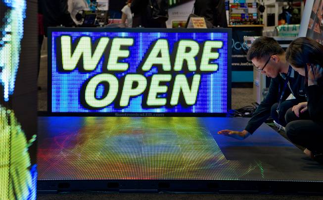 A team from the DesignLED Technology Co. works to get a flexible LED screen working during the National Association of Broadcasters show at the Las Vegas Convention Center on Tuesday, April 8, 2014.