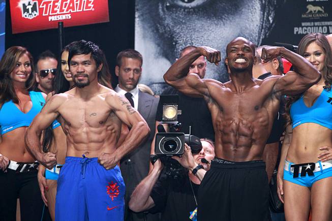 Boxer Manny Pacquiao, left, of the Philippines and undefeated WBO welterweight champion Timothy Bradley pose during an official weigh-in at the MGM Grand Garden Arena Friday, April 11, 2014. Pacquiao will challenge Bradley at the arena on Saturday. The fight is a rematch to a June 9, 2012 fight that Bradley won.
