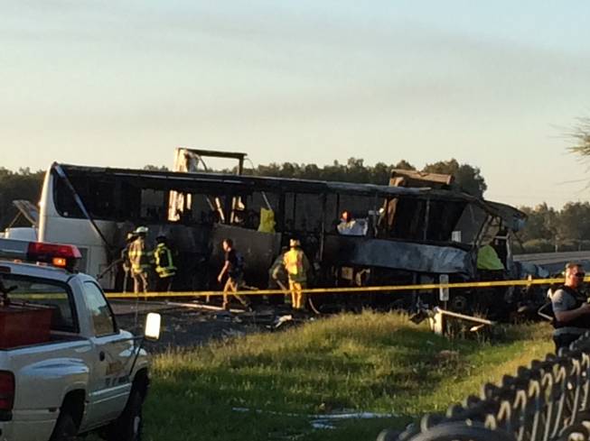 In this photo provided by Andrew Hutchens, authorities work the scene where nine people were killed in a three-vehicle crash involving a bus carrying high school students on a visit to a college, Thursday, April 10, 2014, near Orland, Calif.