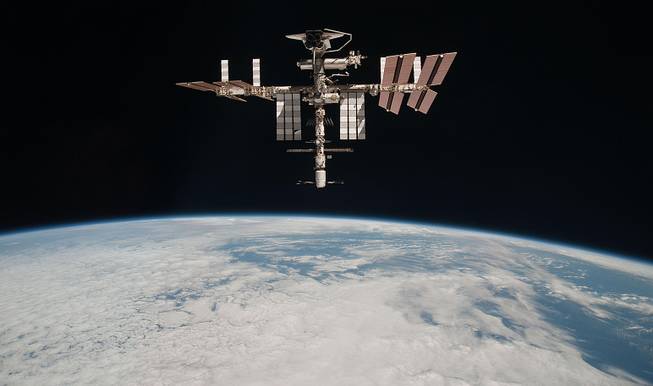 This May 23, 2011, photo shows the International Space Station at an altitude of approximately 220 miles above the Earth, taken by Expedition 27 crew member Paolo Nespoli from the Soyuz TMA-20 following its undocking. 
