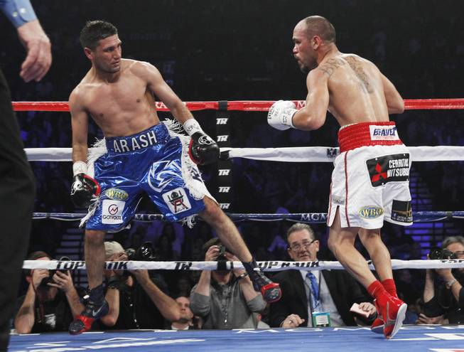 Arash Usmanee leaps away from Ray Beltran during a 10-round lightweight fight at the MGM Grand Garden Arena on Saturday, April 12, 2014.