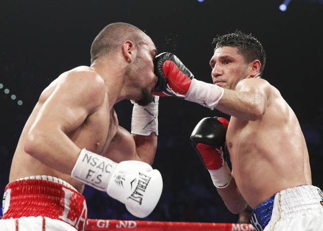 Arash Usmanee of Canada hits Ray Beltran of Mexico with a left during a 10-round lightweight fight at the MGM Grand Garden Arena on Saturday, April 12, 2014.