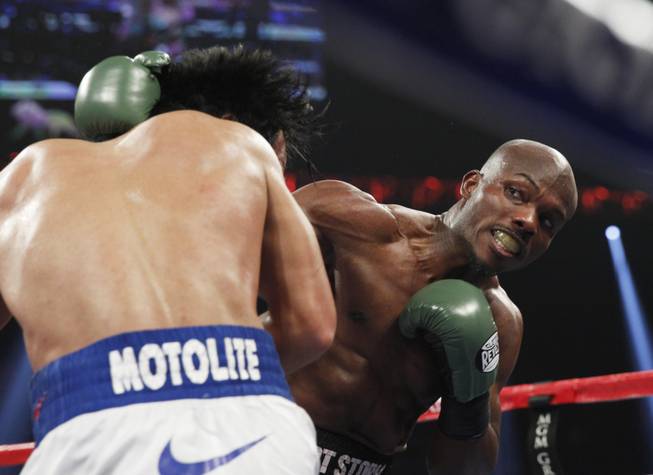 Manny Pacquiao, left, is hit with a right from undefeated WBO welterweight champion Timothy Bradley during their title fight at the MGM Grand Garden Arena on Saturday, April 12, 2014.