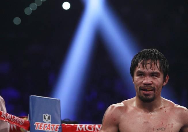 Manny Pacquiao heads to his corner between rounds of his title fight against Timothy Bradley at MGM Grand Garden Arena on Saturday, April 12, 2014. Pacquiao won a unanimous decision.