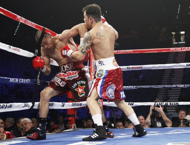 Jose Felix (left) of Mexico is forced into the ropes by Bryan Vazquez of Costa Rica during their WBA interim super featherweight fight at the MGM Grand Garden Arena on Saturday, April 12, 2014.