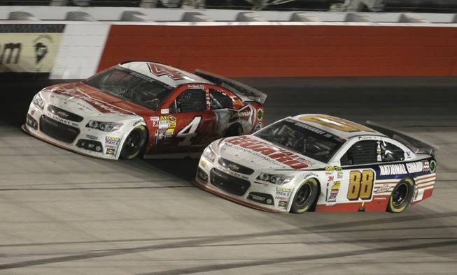 Kevin Harvick (4) passes Dale Earnhardt Jr (88) in Turn 4 on the next-to-last lap during the NASCAR Sprint Cup auto race at Darlington Raceway in Darlington, S.C., on Saturday, April 12, 2014. Harvick won the race.