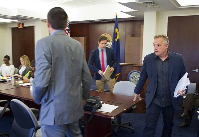 Chris Ramirez, right, producer of Lola Pictures, right, leaves the table after a presentation to the Nevada Economic Development Commission hearing at the Sawyer State Building Monday, April 14, 2014. A production company called LPF One DTIG LLC and affiliated with the Downtown Project is applying for a tax incentive for a proposed movie production starring Dakota Fanning that will be filmed in Las Vegas.