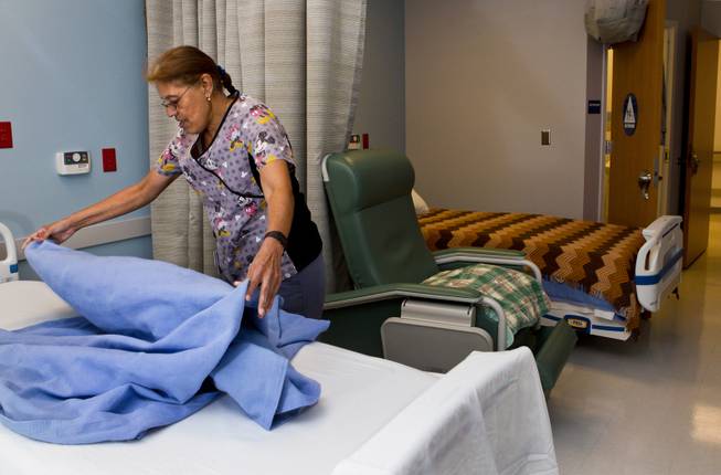 Certified nursing assistant Patricia Peralta makes up a bed in the geriatric behavioral medicine center at Boulder City Hospital on Monday, April 14, 2014. The hospital is banking on an expansion and renovation to help solve its financial troubles.