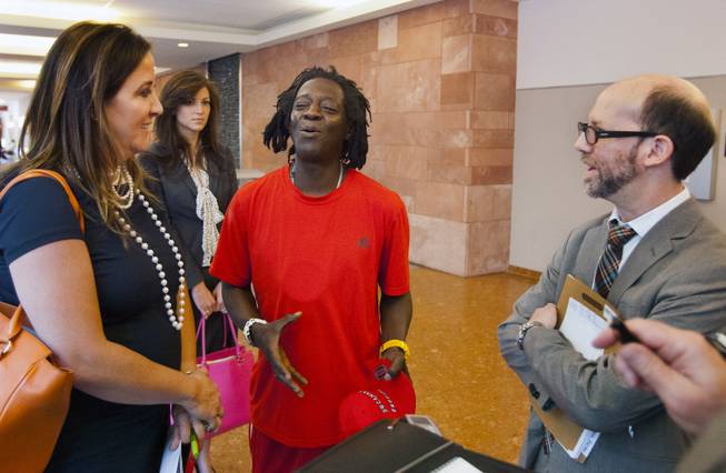 William Jonathan Drayton, Jr., aka Flavor Flav, jokes around with his lawyers Kristina Wildeveld and Dayvid Figler following his appearance before Judge Kathy Hardcastle at the Regional Justice Center on Monday, April 14, 2014.