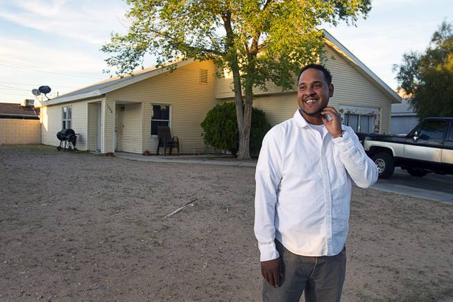 Damarlo Price stands in front of his home on Jackson Avenue Monday, April 14, 2014. Virginia Price, Damarlo's mother, was the first habitat for humanity recipient in Las Vegas. She received the home in 1991. Damarlo Price was raised in the home and still lives in it. His mother has moved to Texas.