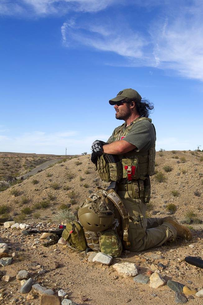 Reid Hendricks of Camden, Tenn. takes up a position on a hill by Cliven Bundy's ranch near Bunkerville Tuesday, April 15, 2014. Hendricks is a former Marine (honorably discharged), and has worked as a police officer and a high school history teacher, he said.