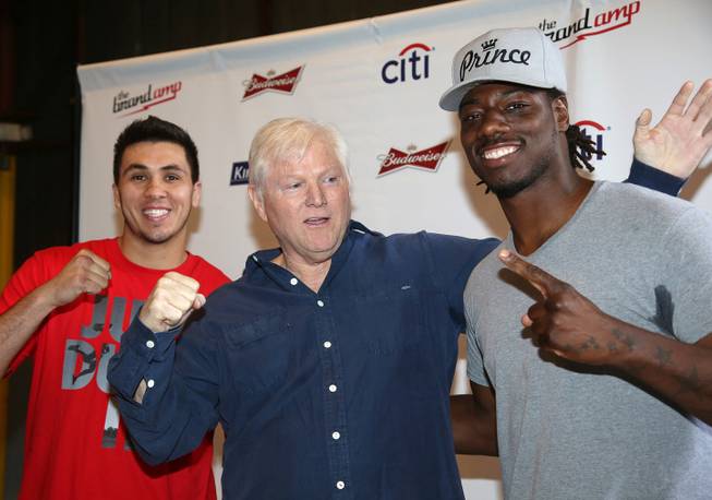 Michael King, center, president of King Sports, stands with heavyweight boxers Charles Martin and Alex Flores during a weigh-in Tuesday, April 15, 2014, in Santa Monica, Calif., for Wednesday's "Boxing at Baker" at the Baker Hangar in Santa Monica.