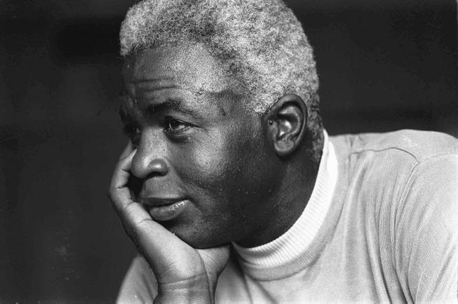 In this June 30, 1971, file photo, Jackie Robinson poses at his home in Stamford, Conn. Baseball holds tributes across the country on Jackie Robinson Day, Tuesday, April 15, 2014, the 67th anniversary marking the end of the game's racial barrier. 