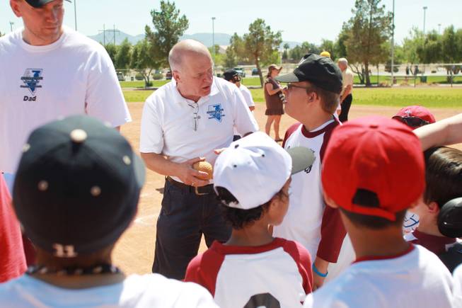 Tom Taycher talks to players on the Loan Writers team as Silverado Little League hosts Challenger Little League day Saturday, April 12, 2014.