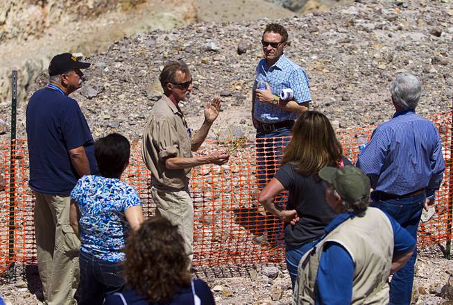 Christopher Ross, center, a senior field scientist with Robsin Engineering, and a member of Barrick's Education Committee, speaks during the 25th Annual Southern Nevada Earth Science Education Workshop Wednesday, April 16, 2014. The tour included a trip to include a visit to the Barrick's Bullfrog Mine and the ghost town of Rhyolite. Teachers spent the first day of the workshop focused on classroom activities related to rocks and minerals.