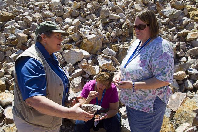 Daohne LaPointe, left, a member of the Nevada Mining Association, talks about rocks with Delta Academy teacher Jennifer Harnden, right, and Meadows School teacher Kimberly Cagle during the 25th Annual Southern Nevada Earth Science Education Workshop Wednesday, April 16, 2014. The tour included a trip to include a visit to the Barrick's Bullfrog Mine and the ghost town of Rhyolite. Teachers spent the first day of the workshop focused on classroom activities related to rocks and minerals.