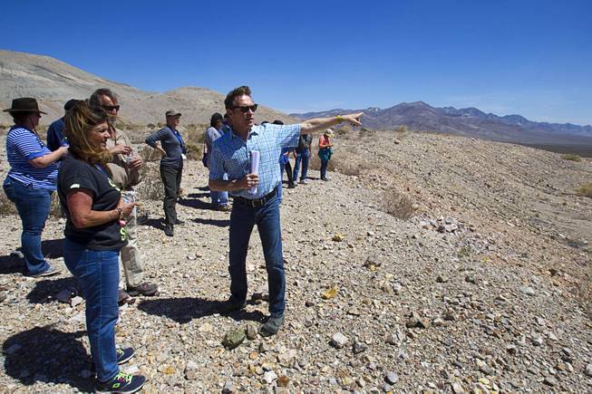 Barrick's Tim Buchanan points out features of the new Bullfrog Mine near Beatty during the 25th Annual Southern Nevada Earth Science Education Workshop Wednesday, April 16, 2014. The gold and silver mine was in operation from 1988 to 1999. The tour also included a trip the ghost town of Rhyolite. Teachers spent the first day of the workshop focused on classroom activities related to rocks and minerals.