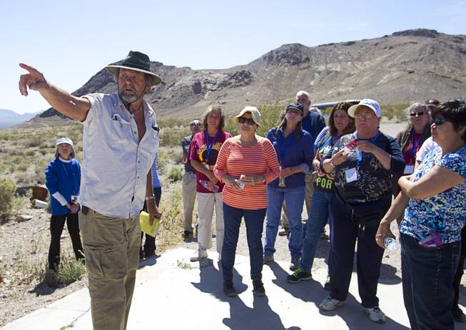 Karl Olson, the self-declared Mayor of Ryholite, talks with teachers about the history of the mining town during the 25th Annual Southern Nevada Earth Science Education Workshop Wednesday, April 16, 2014. The tour also included a visit to the Barrick's Bullfrog Mine. Teachers spent the first day of the workshop focused on classroom activities related to rocks and minerals.