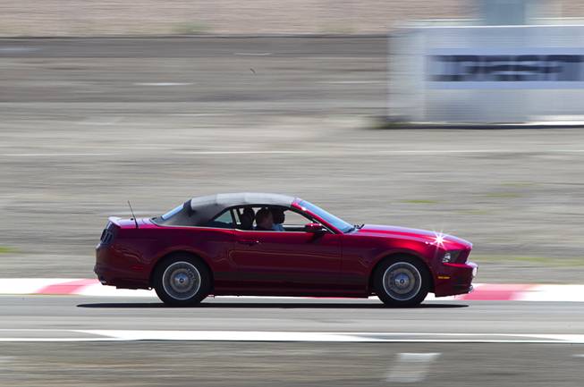 A late-model Mustang convertible drives on an infield course during the Mustang 50th Birthday Celebration at the Las Vegas Motor Speedway Thursday, April 17, 2014. The celebration continues through Sunday.