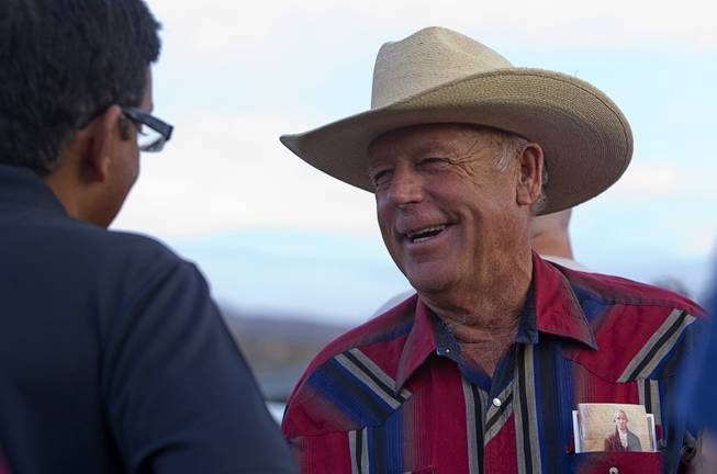 Rancher Cliven Bundy, right, greets a supporter during a Bundy family "Patriot Party" near Bunkerville on Friday, April 18, 2014. The family organized the party to thank people who supported Bundy in his dispute with the Bureau of Land Management.
