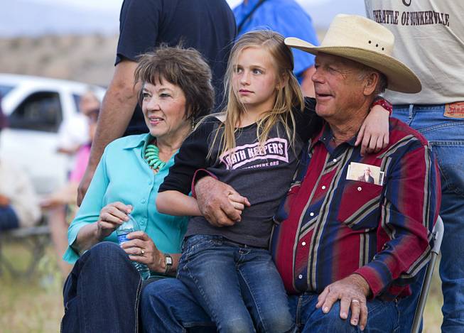 Rancher Cliven Bundy, his wife Carol and his granddaughter Jerusha Bundy, 10, listen to live music  during a Bundy family "Patriot Party" near Bunkerville Friday, April 18, 2014. The family organized the party to thank people who supported Bundy in his dispute with the Bureau of Land Management.