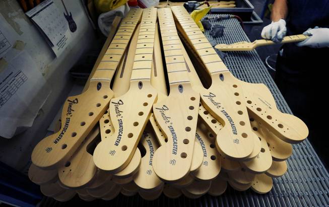 Fender Stratocaster necks are prepared for assembly at the Fender factory in Corona, Calif. on Tuesday, Oct. 15, 2013. The electric guitar, used by countless professional and amateur musicians, celebrates its 60th anniversary in 2014.