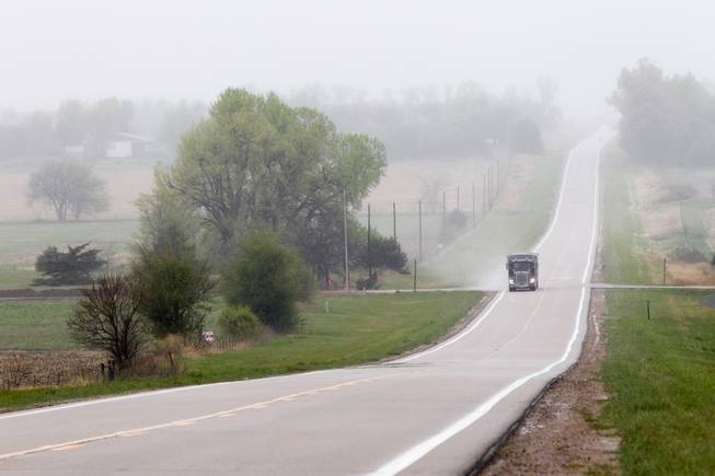 This April 19, 2012, file photo shows a truck traveling along Highway 14, several miles north of Neligh, Neb., near the proposed new route for the Keystone XL pipeline. The US is extending indefinitely the amount of time federal agencies have to review the Keystone XL pipeline, the State Department said Friday.